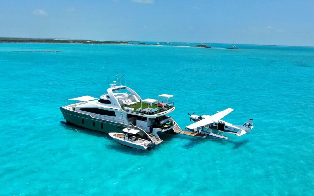 tropic airways Sea plane with a superyacht in the Bahamas
