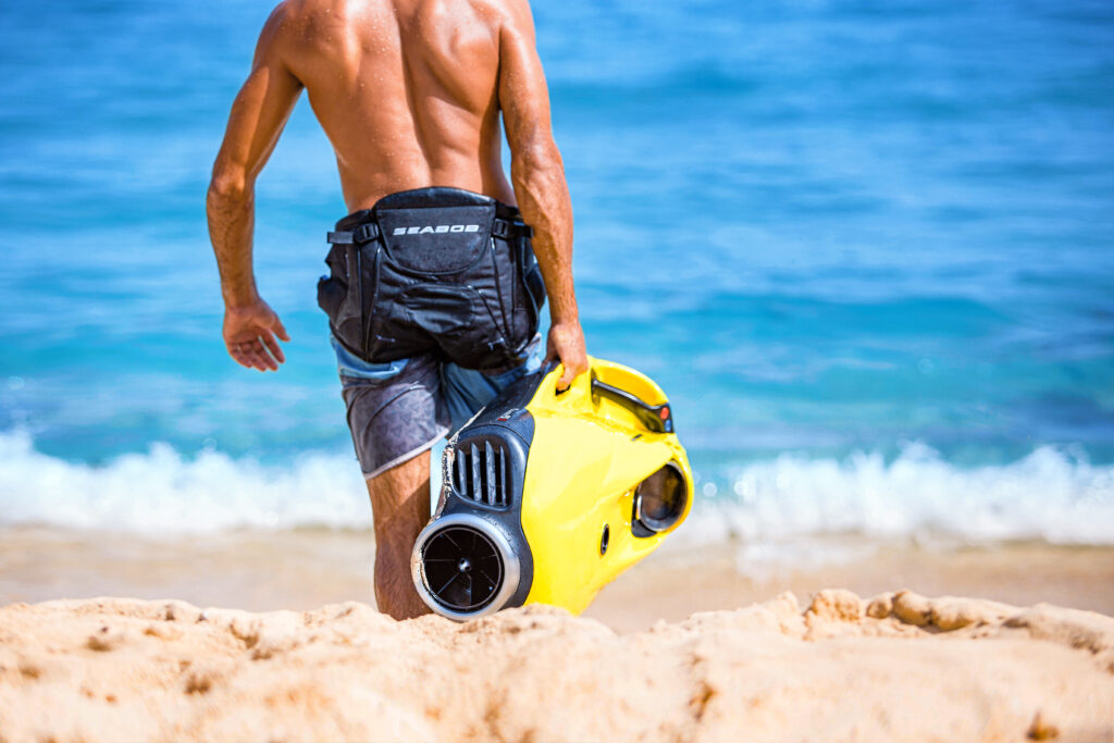 Carrying seabob on a beach