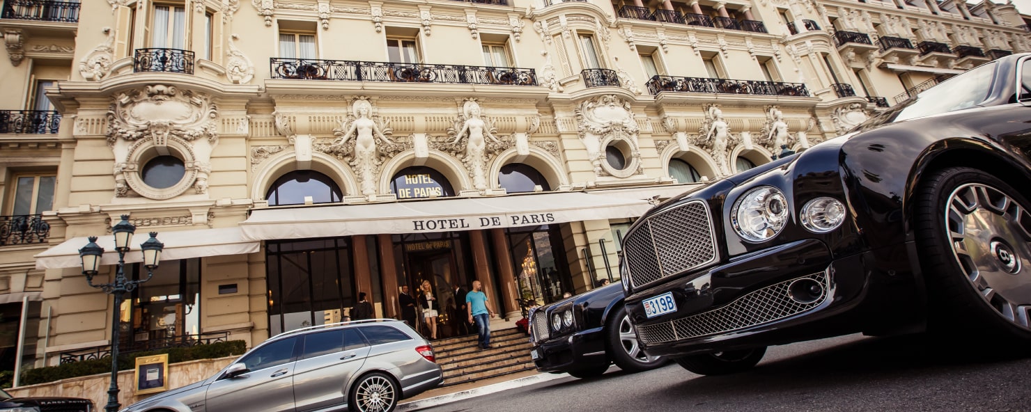 Hotel de Paris with luxury cars parks in front
